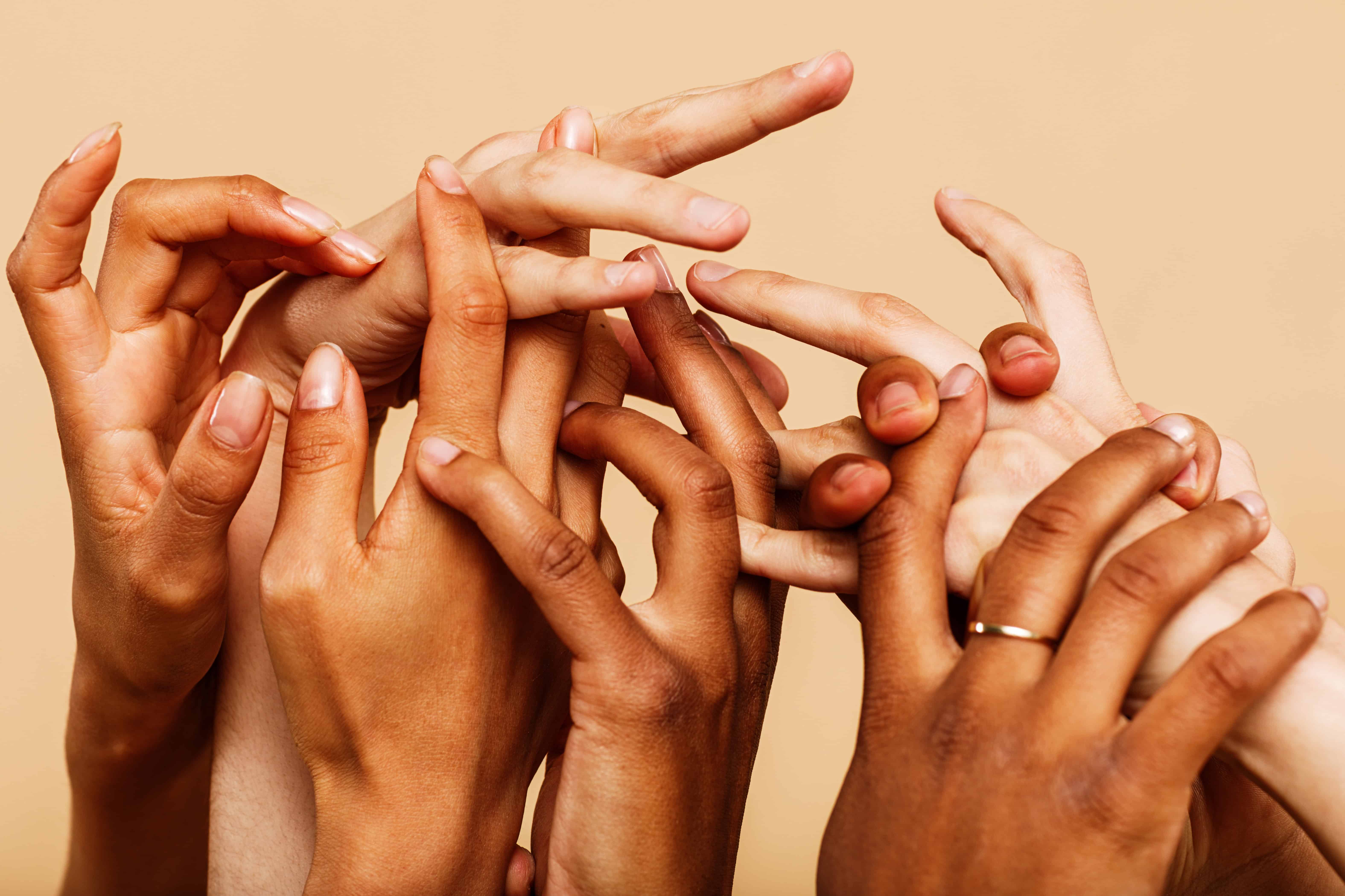 close-up-shot-of-a-group-of-hands-reaching-up